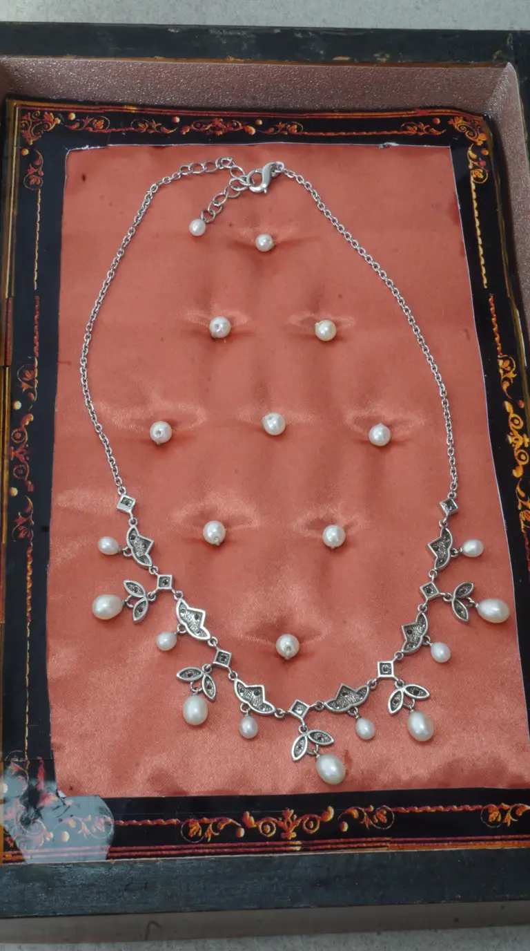 Vintage sterling silver pearl necklace with dangling freshwater drops and Art Deco marcasite-style accents.