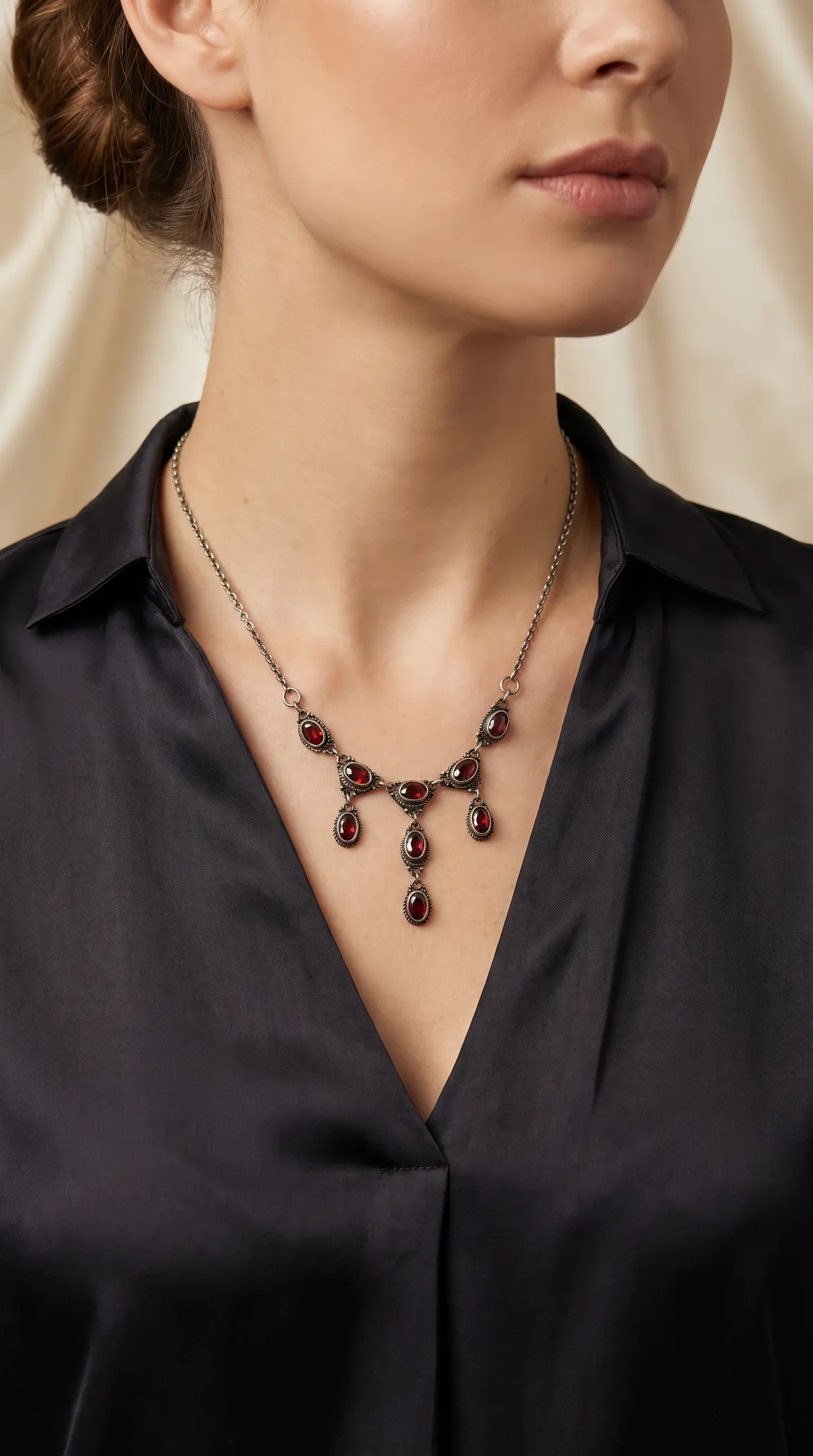 Vintage red garnet and silver necklace with antique design worn by a woman
