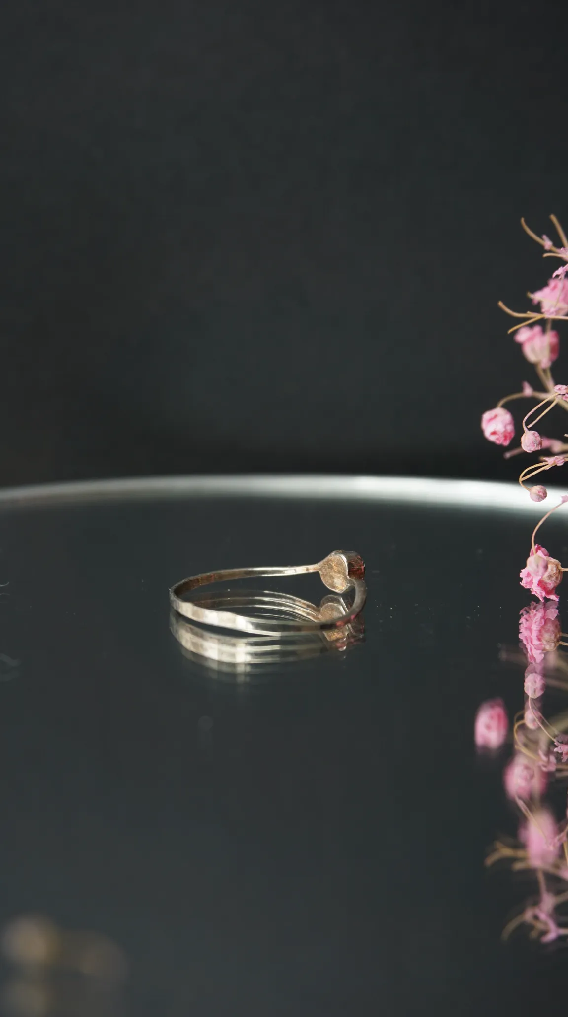 Vintage sterling silver hammered open-cuff ring with garnet gemstone.