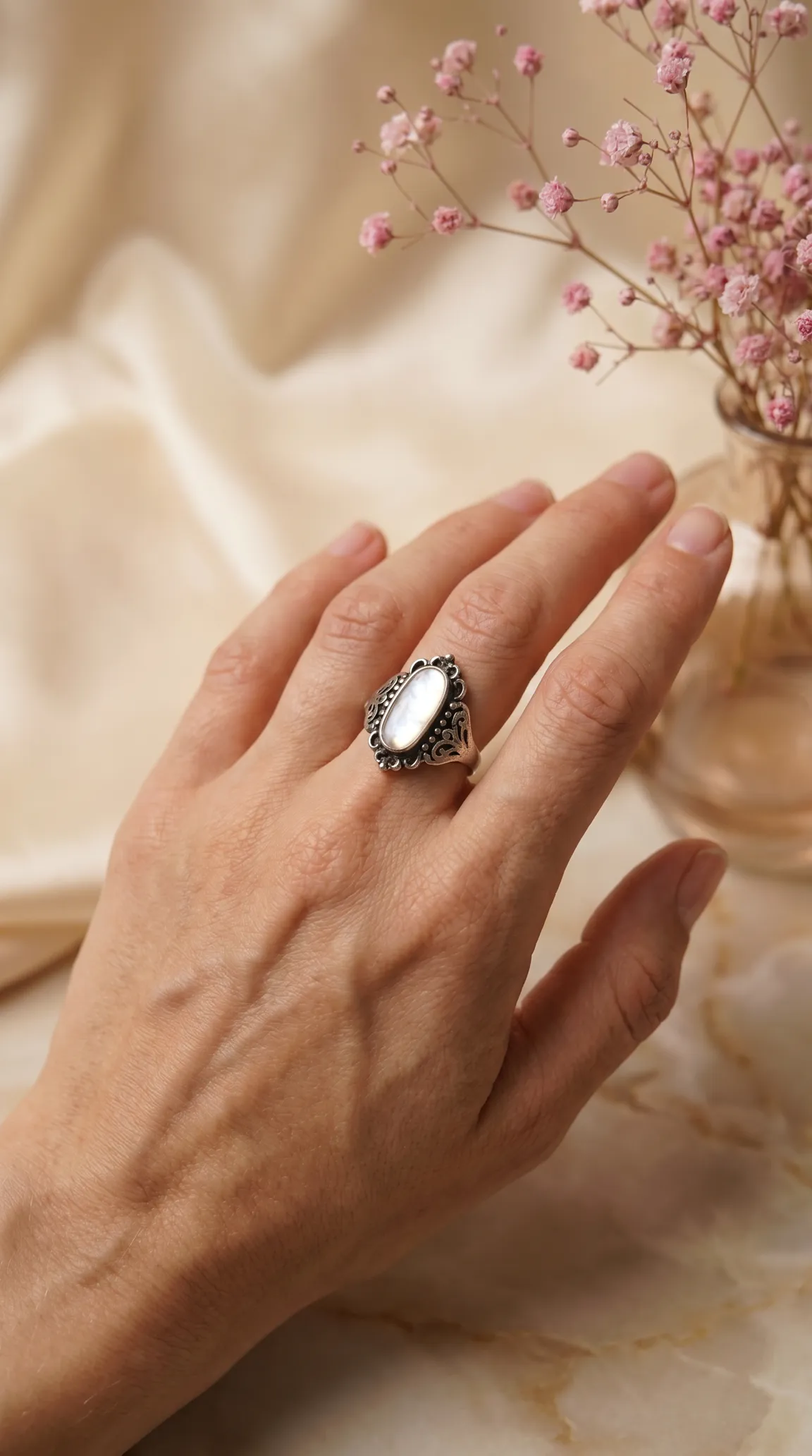 Vintage sterling silver mother of pearl filigree ring on hand