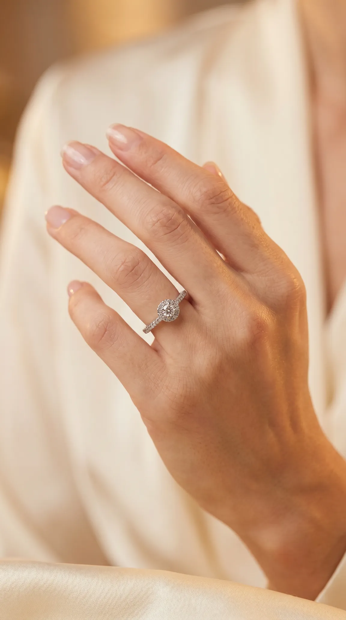 Vintage diamond halo engagement ring on a woman's hand